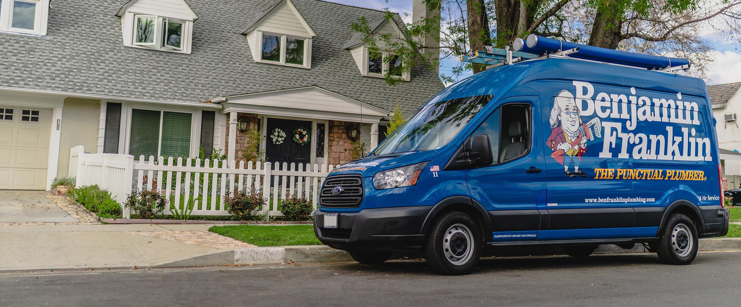 Benjamin Franklin Plumbing service van in front of house