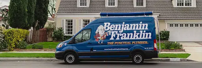 Benjamin Franklin Plumbing service van in front of house