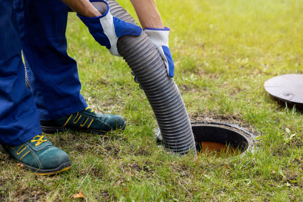hands holding hose in septic system