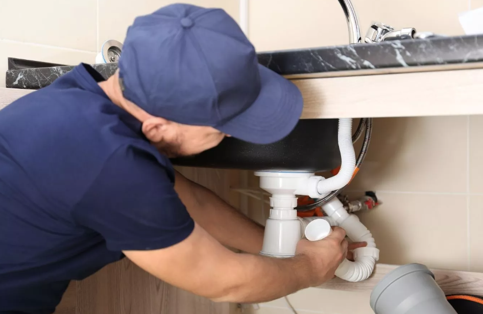 A Benjamin Franklin Plumbing expert fixing a pipe in Pinal County, AZ, showcasing professional plumbing solutions for homeowners.