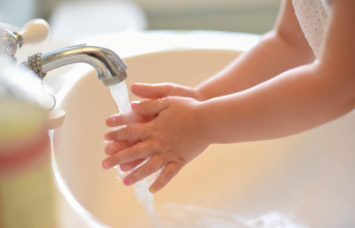 Water softener stock image of child washing her hands